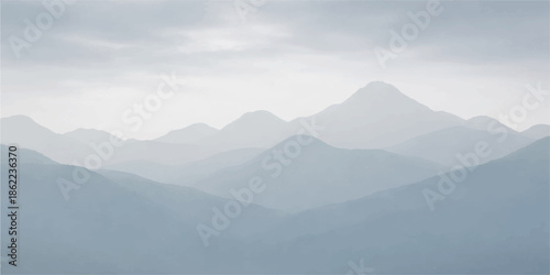A breathtaking sunrise illuminates a misty mountain landscape where peak silhouettes pierce through blue fog and golden clouds over a vast forest valley