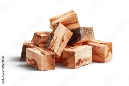 A pile of roughly cut, seasoned wood blocks, mostly light brown with some darker bark