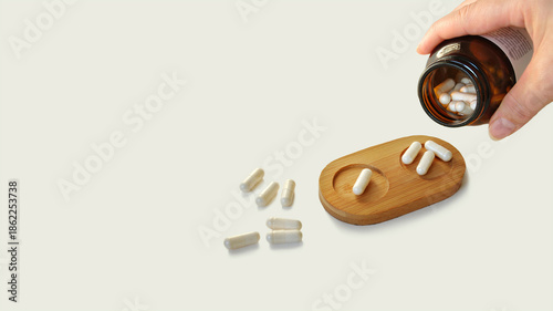 Spilled pills, medicine dosage tray, bottle in hand. Medicine dosage, prescription medicine, food supplement tablets, beauty pills, pain killers. Placebo effect. Pharmacy business. Bowel cleansing