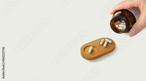 Spilled pills, medicine dosage tray, bottle in hand. Medicine dosage, prescription medicine, food supplement tablets, beauty pills, pain killers. Placebo effect. Pharmacy business. Health care
