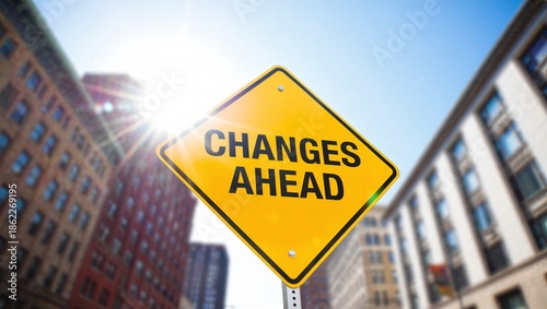 yellow diamond shaped changes ahead street sign warning of upcoming transitions and new directions on urban city background