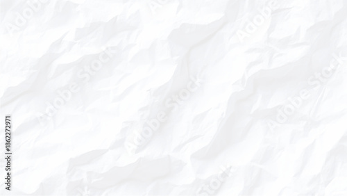 A close up view of crumpled white paper shows intense texture and deep shadows creating an abstract pattern