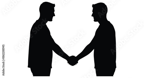 Silhouette of two men facing each other shaking hands in a formal agreement or greeting