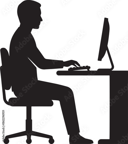 Silhouette of woman working on computer at office desk