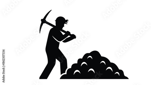 Silhouette of a miner with a pickaxe standing near a pile of excavated material