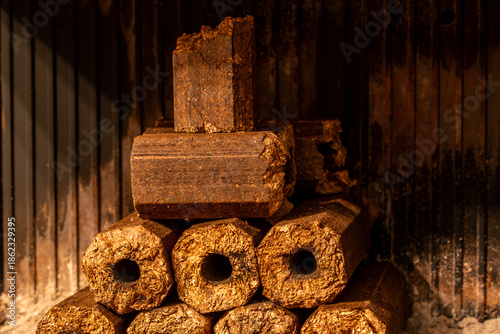Stacked oak briquettes in fireplace