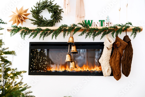 Bild auf Leinwand Cozy Christmas fireplace with stockings hanging and warm glowing fire, festive g