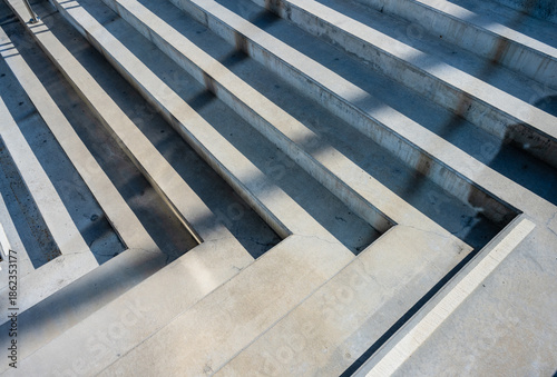 Abstract concrete steps creating geometric shadow pattern.