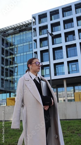 Wallpaper Mural Vertical screen sad young woman after failed job interview walks near office holding laptop disappointed mood career setback urban workday emotion uncertainty moment Torontodigital.ca