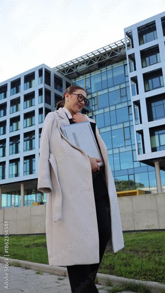 custom made wallpaper toronto digitalVertical screen confident young woman holding laptop and documents outside modern office building after finishing important work showing relief pride and success