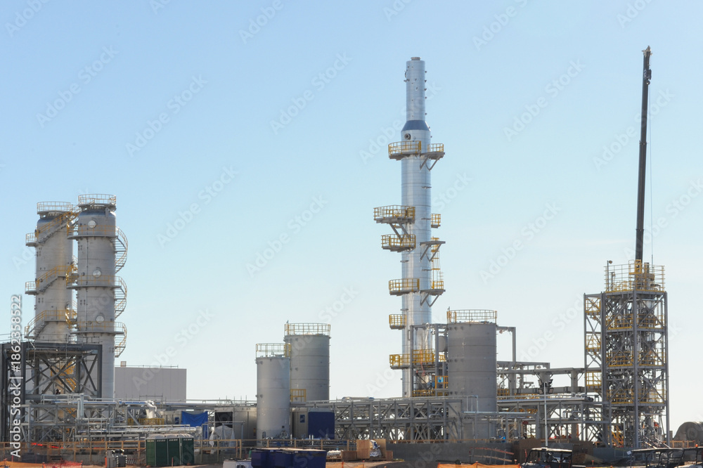 Fototapeta premium Industrial processing towers and piping infrastructure at a large battery manufacturing plant, representing energy storage production facilities and utility scale industrial operations