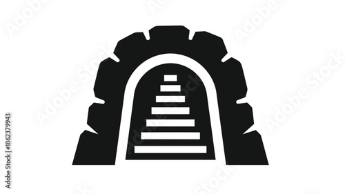 A dark stone archway with steps leading upwards into an unknown shadowed opening