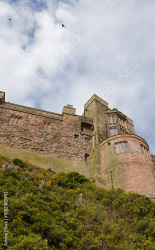 Historic Stone Castle on Hill Under Cloudy Sky – Bamburgh Castle - England