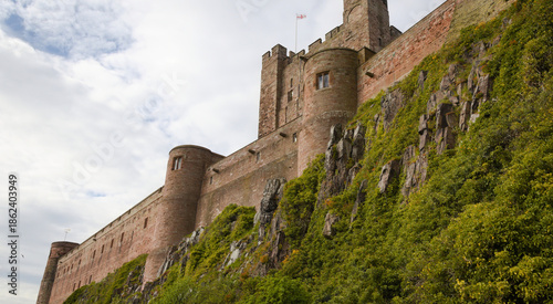 Historic Castle on Rocky Hill with Greenery – Bamburgh Castle - England