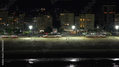 Aerial tracking shoot of Copacabana Beach at night, Rio de Janeiro, Brazil	
