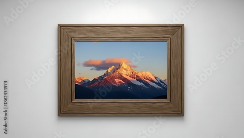 A framed mountain sunset on a plain wall