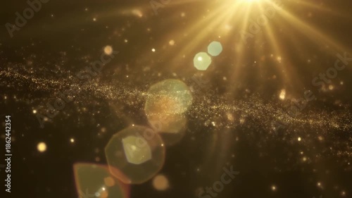 Golden light shining through sparkling particles in a dark environment viewed from above