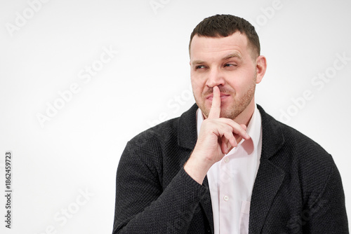 Slika na platnu Man saying hush and be quiet with finger on lips gesture