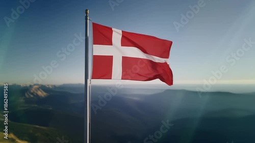 Denmark flag waving on mountain peak with breathtaking landscape