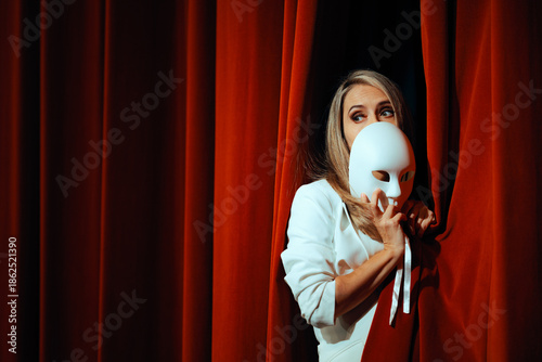 Fotografija Actress Hiding Behind Curtains and Theatrical Mask