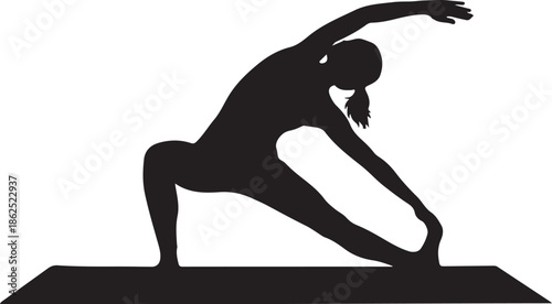 A woman practices yoga on a mat indoors