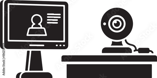 A computer monitor and webcam on a desk