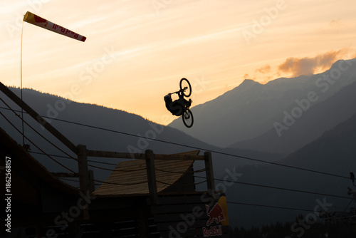 Quadro su tela Silhouetted Mountain Biker Inverted Mid-Air Against Sunset in Whistler, British