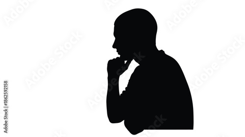 A thoughtful man in a black silhouette hand to chin in contemplation