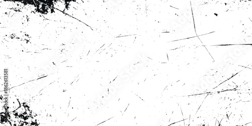A stark high contrast image showcasing a white grunge surface with scattered dark lines and textures resembling cracks