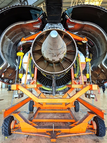 Rear view of turbofan aircraft engine installation inside hangar showcasing aviation technology, maintenance precision, and industrial engineering