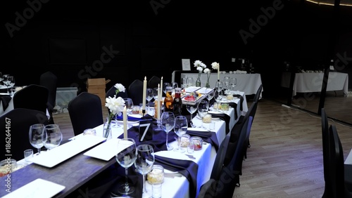 Tableau sur toile Sophisticated table setting featuring white carnations, candles, wine glasses, p