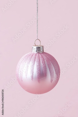 pink christmas ornament on a pink background