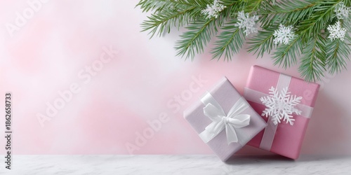 pink christmas background with gift boxes, snowflakes, and fir branches