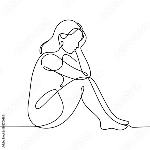 Sad woman sits alone curled up resting her head on knee now.