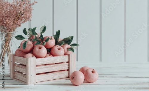 Fresh pink apples in wooden crate with green leaves and white background