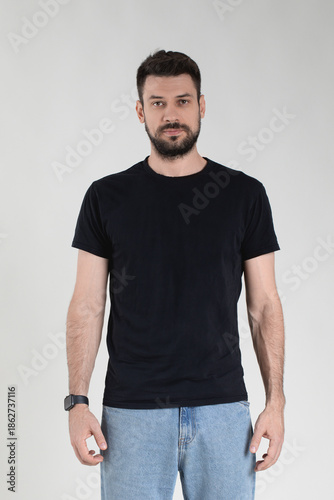 Handsome Caucasian 35 years old man in black T-shirt with neutral facial expression.
