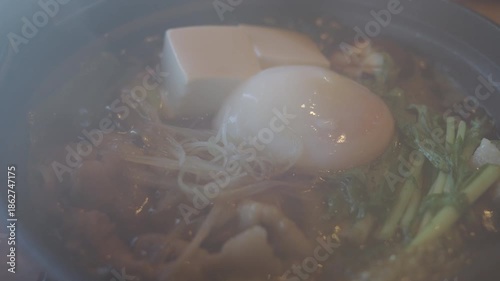 Japanese food, Sukiyaki, Kurobuta pork, egg, tofu, and vegetables.