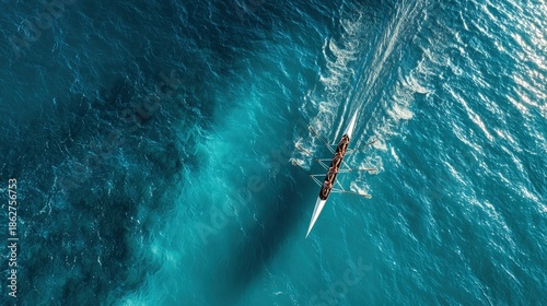 Women's rowing team practices on blue water, captured from above during sunny weather
