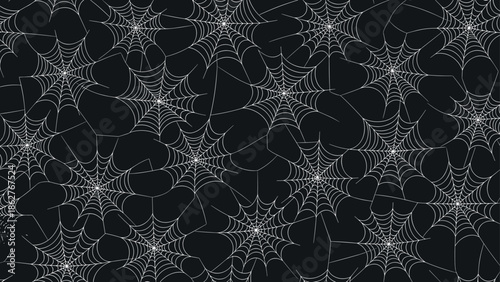 Intriguing seamless pattern of white spider webs on a black background creates a spooky and mysterious Halloween texture.