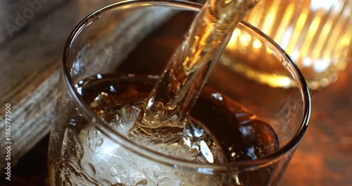 Slow Motion 1000fps Pouring Whiskey Or Dark Spirits Into Elegant Glass With Ice Ball, Premium Alcohol, Rustic Wooden Table, Macro Close Up