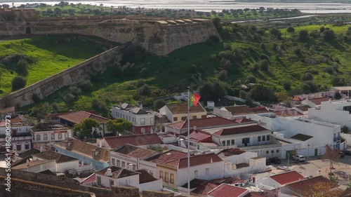 Portuguese flag waving in Castro Marim Algarve with medieval fortress