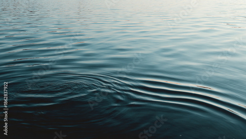 A bright water surface moments after all ripples have fully disappeared, absolute stillness, smooth and calm, high-key lighting, minimal realism