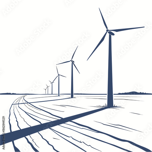 Wind turbine shadows on snowy field with distant mountains
