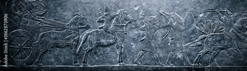 Assyrian relief on the wall. Historical and culturical background on the theme of civilizations of Assyria, Mesopotamia, Babylon, interfluve, Sumerian.