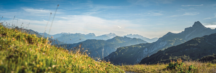 Foto auf Acrylglas Alpen Panoramic alpine view from near Freiburger Hütte and Formarinsee looking south over the Klostertal valley toward the Montafon region, surrounded by rugged peaks of the Austrian Alps.  © ikoon