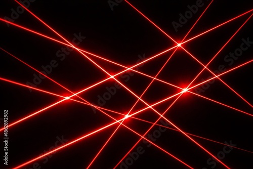 Intersecting red lasers on black background