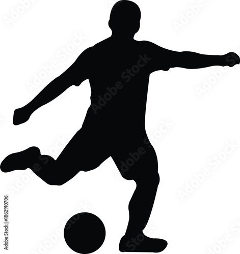 Silhouette of a person kicking a soccer ball in motion