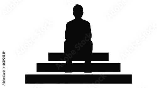 Silhouette of a person meditating in a lotus position on steps