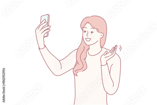 Young woman taking selfie and waving to camera with bright smile, beauty and social content vibe, soft lighting and confident pose for vlogging or lifestyle post, friendly engagement gesture