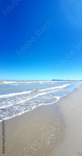Beach and blue sky with white clouds. Seascape.